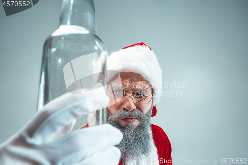 Image of Funny guy in christmas hat. New Year Holiday. Christmas, x-mas, winter, gifts concept.