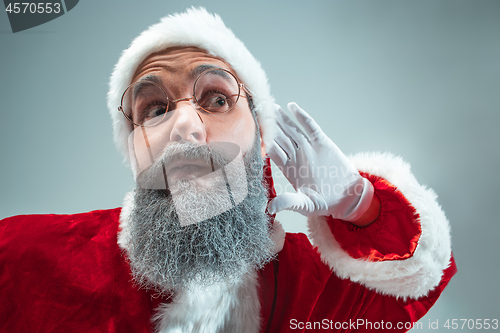 Image of Funny guy in christmas hat. New Year Holiday. Christmas, x-mas, winter, gifts concept.