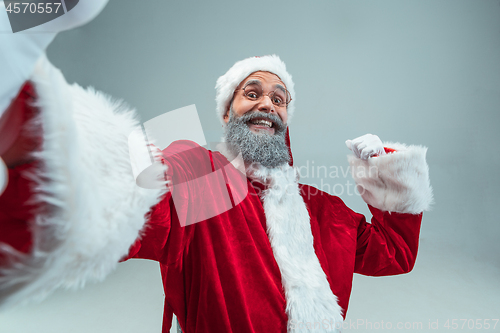 Image of Funny guy in christmas hat. New Year Holiday. Christmas, x-mas, winter, gifts concept.