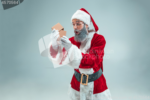 Image of Funny guy in christmas hat. New Year Holiday. Christmas, x-mas, winter, gifts concept.