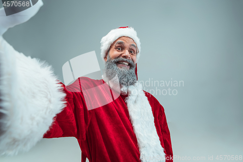 Image of Funny guy in christmas hat. New Year Holiday. Christmas, x-mas, winter, gifts concept.