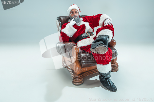 Image of Funny guy in christmas hat. New Year Holiday. Christmas, x-mas, winter, gifts concept.