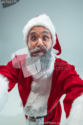 Image of Funny guy in christmas hat. New Year Holiday. Christmas, x-mas, winter, gifts concept.