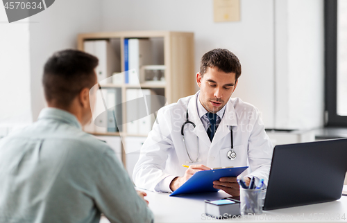 Image of doctor with clipboard and male patient at hospital