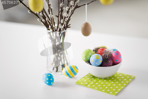 Image of pussy willow branches and colored easter eggs