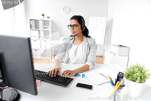 Image of businesswoman with computer working at office