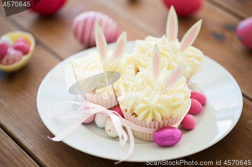 Image of cupcakes with easter eggs and candies on table