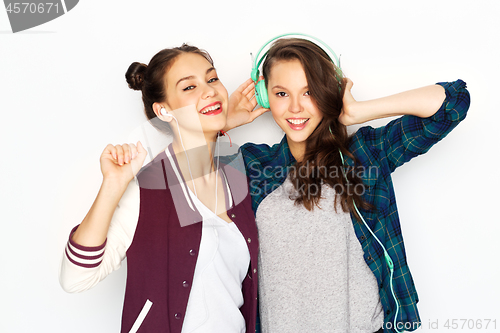 Image of teenage girls in earphones listening to music