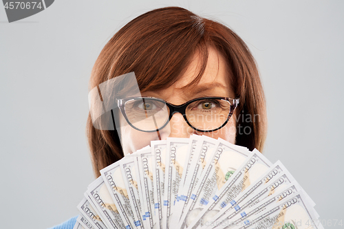 Image of senior woman with hundred dollar money banknotes