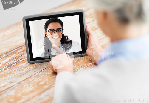 Image of senior woman patient having video call with doctor