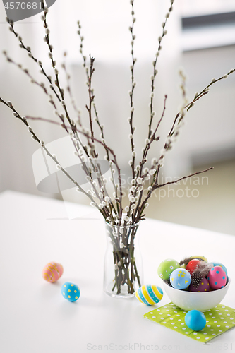 Image of pussy willow branches and colored easter eggs