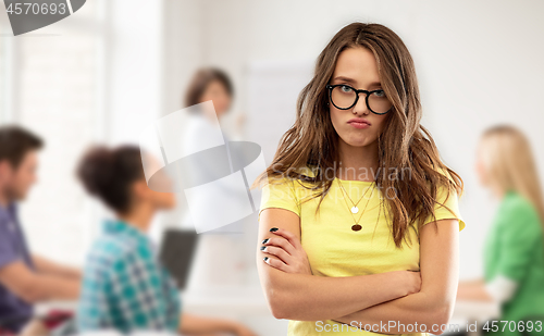 Image of teenage student girl in glasses pouting at school