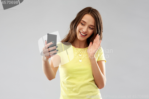 Image of smiling teenage girl having video call smartphone