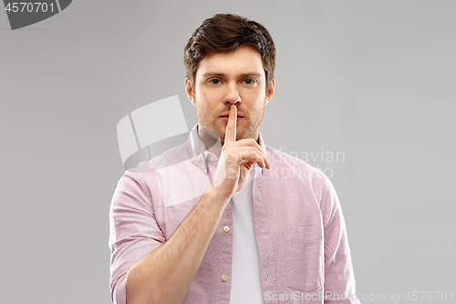 Image of young man with finger on lips