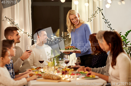 Image of happy family having dinner party at home