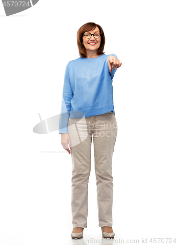 Image of senior woman in glasses pointing finger to you