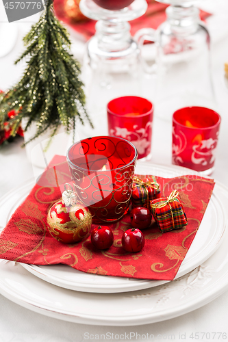 Image of Christmas And New Year Holiday Table Setting.  Place setting for Christmas Dinner. Holiday Decorations. 