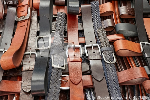 Image of Leather belts at a market