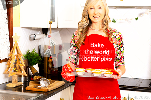 Image of A woman with baked pastry pies in the kitchen at Christmas time