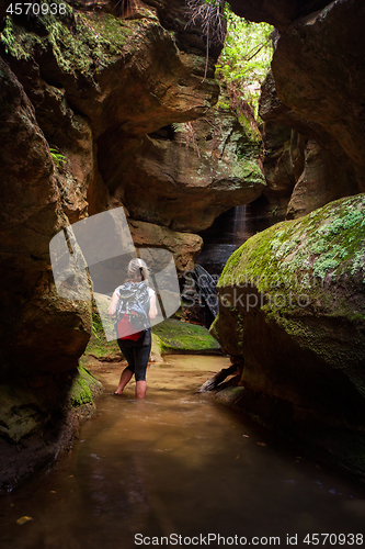 Image of Tourist or female adventurer exploring a canyon 