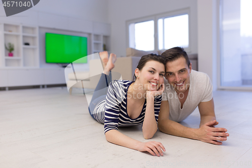 Image of couple lying on the floor at home