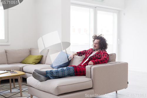 Image of young man in bathrobe enjoying free time