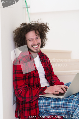 Image of freelancer in bathrobe working from home