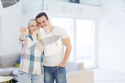 Image of couple showing a keys of their new house