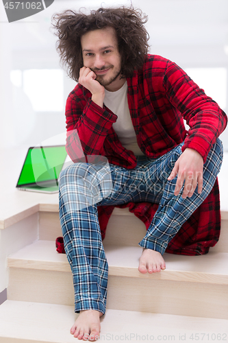 Image of freelancer in bathrobe working from home