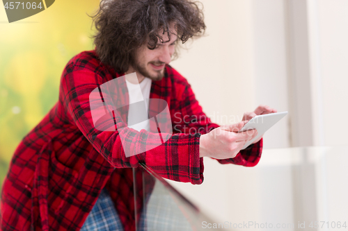 Image of young freelancer using tablet computer