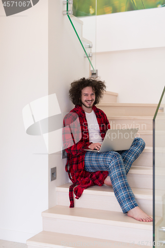 Image of freelancer in bathrobe working from home