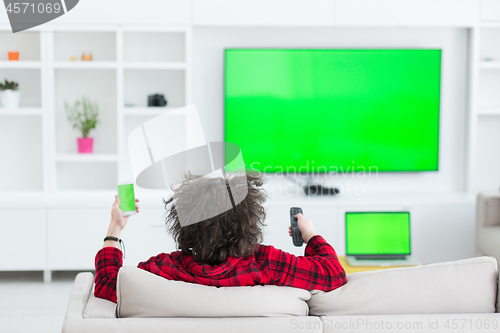 Image of young man in bathrobe enjoying free time