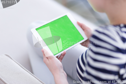 Image of woman on sofa using tablet computer