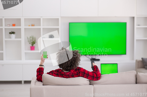 Image of young man in bathrobe enjoying free time