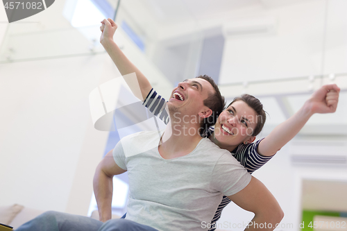 Image of handsome man piggybacking his girlfriend