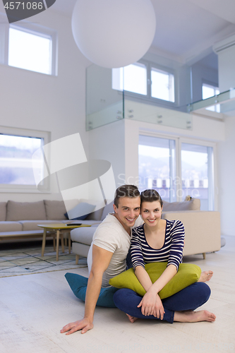 Image of couple sitting on the floor at home