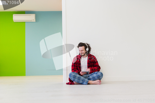 Image of young man enjoying music through headphones
