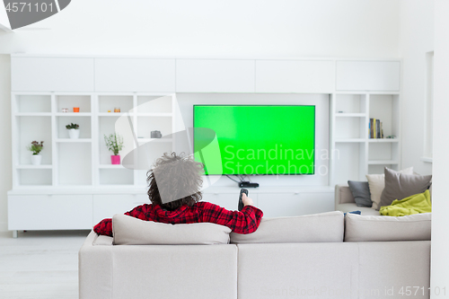 Image of young man in bathrobe enjoying free time