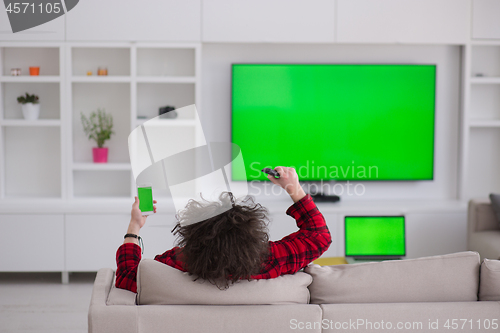 Image of young man in bathrobe enjoying free time