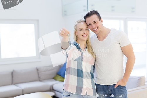 Image of couple showing a keys of their new house