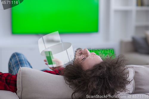 Image of young man in bathrobe enjoying free time