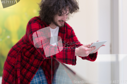 Image of young freelancer using tablet computer