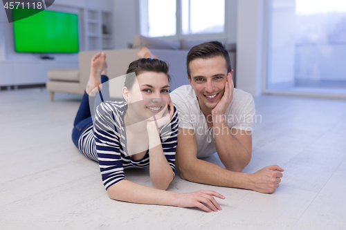 Image of couple lying on the floor at home