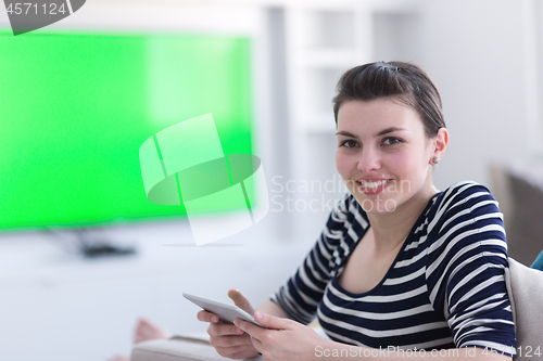 Image of woman on sofa using tablet computer