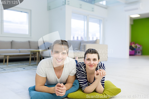 Image of couple lying on the floor at home