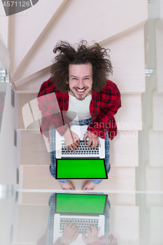 Image of freelancer in bathrobe working from home