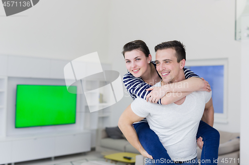 Image of handsome man piggybacking his girlfriend