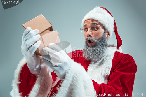 Image of Funny guy in christmas hat. New Year Holiday. Christmas, x-mas, winter, gifts concept.