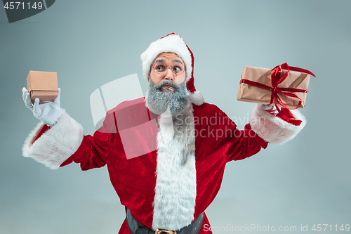 Image of Funny guy in christmas hat. New Year Holiday. Christmas, x-mas, winter, gifts concept.