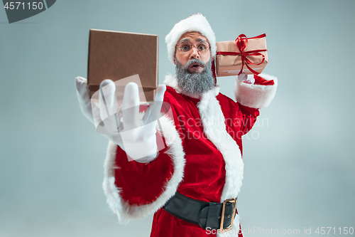 Image of Funny guy in christmas hat. New Year Holiday. Christmas, x-mas, winter, gifts concept.